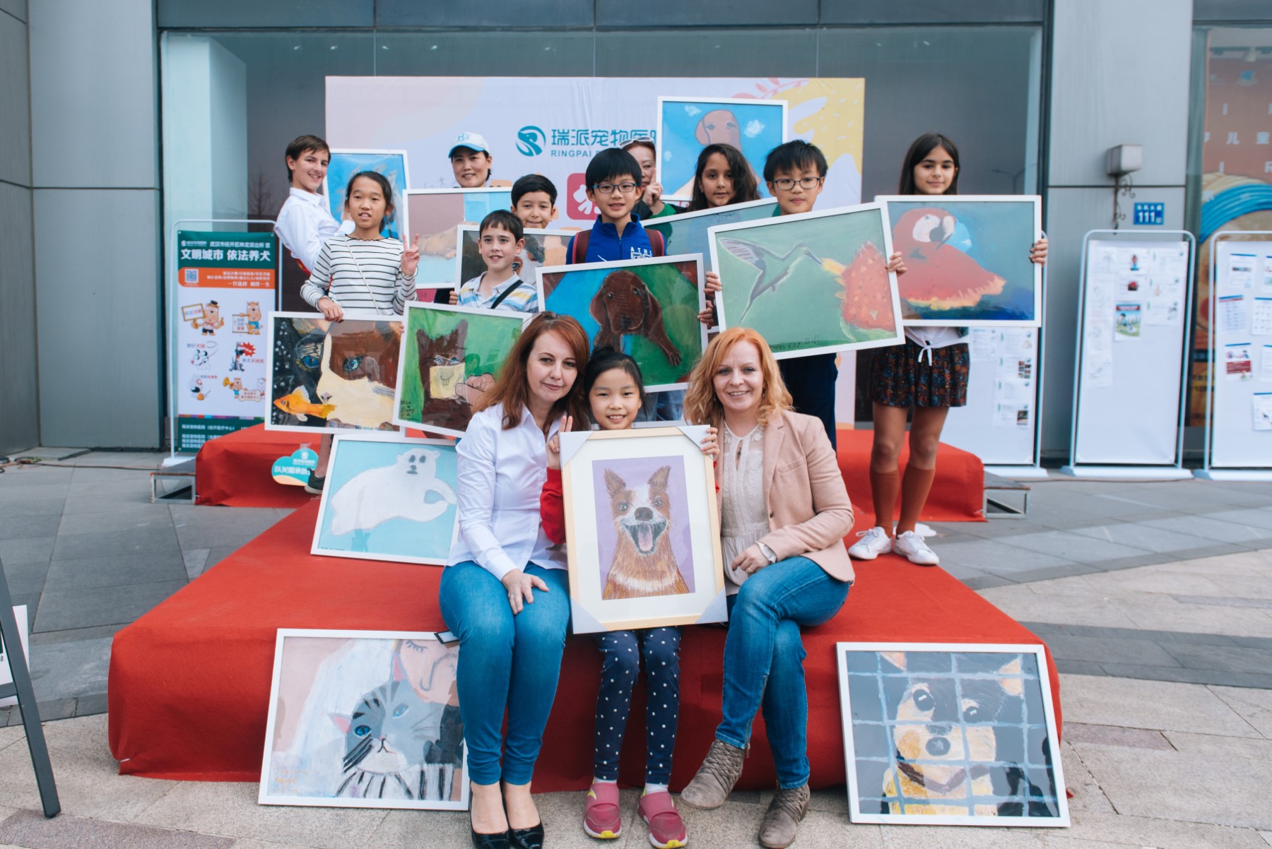 Children with their paintings for the art auction