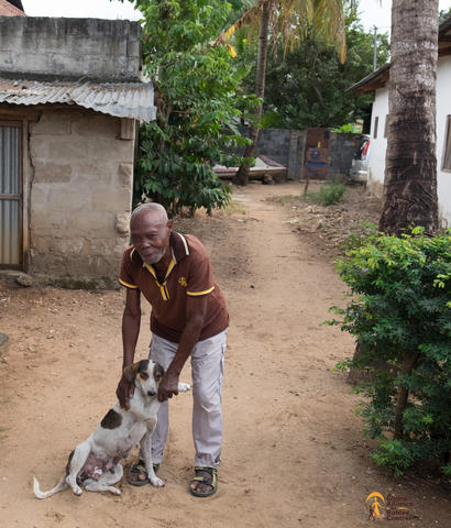 And old man lovingly shakes hands with his dog in Zanzibar during a GARC vaccination drive against rabies. 