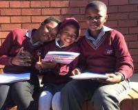 Children at the Meetse School in Pretoria, South Africa with Want a Friend? Be a Friend! booklets. Photo: U of P Vet Students