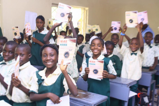School pupils excited after getting educated about rabies and given note books with rabies fact on the cover page