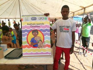 Isaiah, MAlawi's first young ambassador for rabies prevention, teaches fellow school children and shares his own personal story