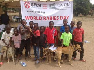Children pose after vaccinate their dogs