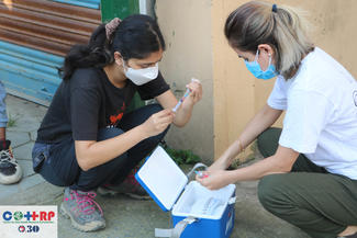 Dr Samiksha Sen and Dr Iebu Devkota loading the vaccines in the syringes