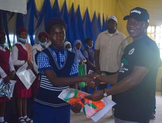 CLUB COORDINATOR, DR. ANDREW ADAMU, PRESENTING A PRIZE TO A STUDENT AT THE SYMPOSIUM