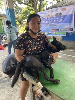 A responsible pet parent carrying her pet to the preparatory area.