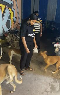 Shruti giving treats to vaccinated dogs