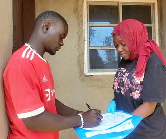 Client filling consent form during free vaccination outreach