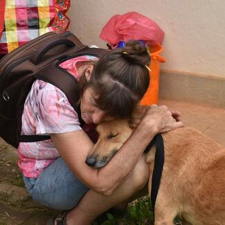Woman hugging community dog