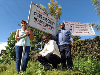 UAWC team erecting vaccination event banner