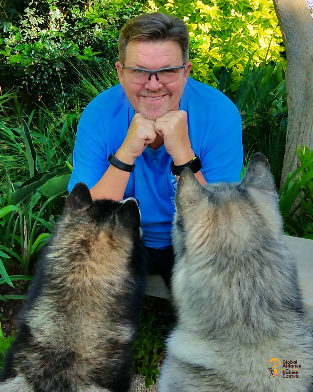 Professor Louis Nel, Executive Director of GARC, sits with his two pet dogs.